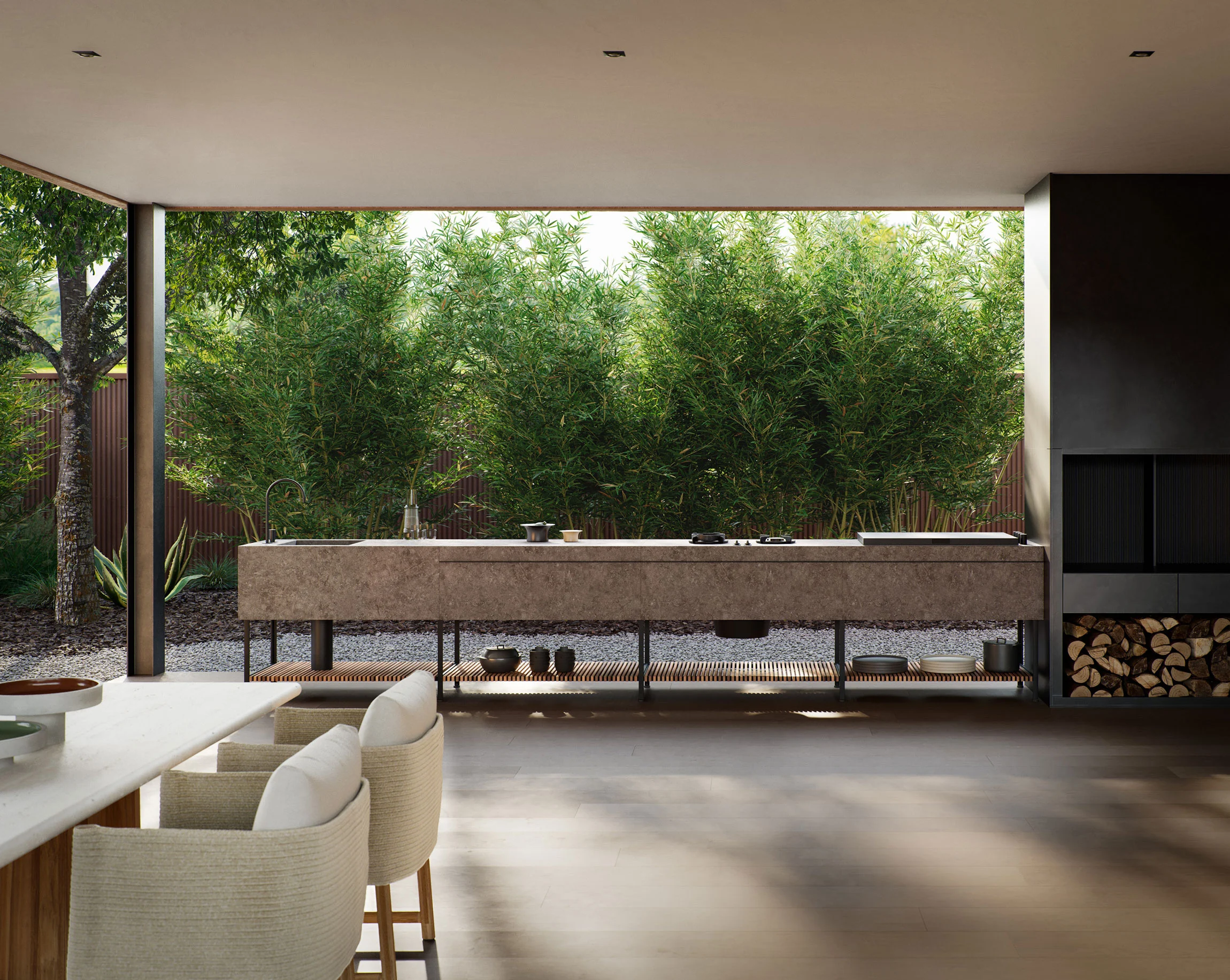 Cuisine extérieure haut de gamme : long plan en pierre avec évier et rangements, vue sur bambous.