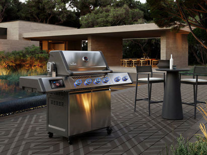 Napoleon Prestige Pro 500VX PRO500VXRSIBPSS installé sur une terrasse moderne au bord d’une piscine, avec écran tactile intégré et boutons LED bleus allumés.