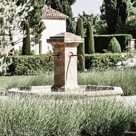 Another serene seating area in the Provençal garden, highlighting the lush greenery and peaceful ambiance of the space