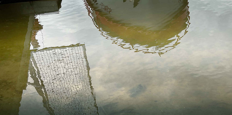 Vandenyje atsispindintys laivas, vartai ir tiltelis, kviečiantys į pokyčius, kuriantys ramybės ir refleksijos pojūtį
