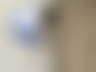 Professional installer laying new carpet in a living room during a carpet installation project.