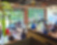 Students learning in large, spacious, accomodating classroom with large window.
