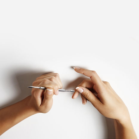 woman-making-manicure-with-metall-stick-cuticle_edited.jpg