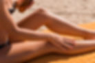 sensuous-slim-woman-applying-suntan-oil.jpg