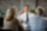 happy-financial-advisor-communicating-with-senior-couple-while-having-meeting-with-them-of