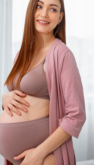 medium-shot-pregnant-woman-posing-home.jpg