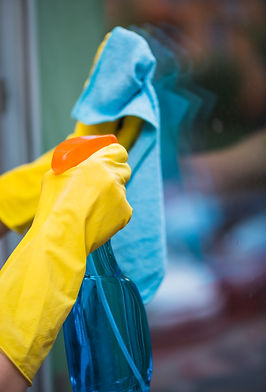 housekeeper-spraying-detergent-with-spray-bottle-glass-window.jpg