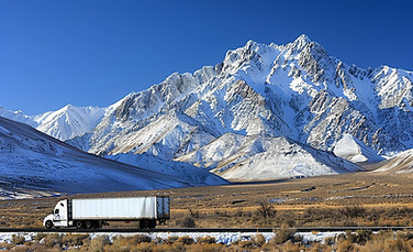 moving-truck-snowy-alpine-pass.jpg