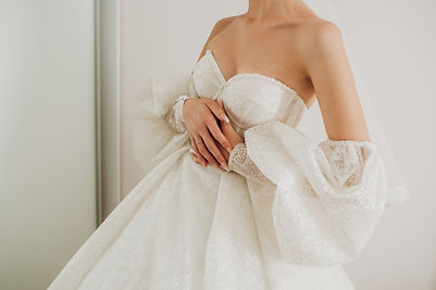 hands-bride-white-wedding-dress-with-gold-engagement-ring-with-diamond-closeup-bride-touch