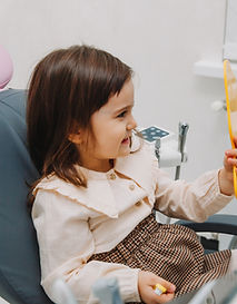 side-view-portrait-little-girl-looking-mirror-pediatric-dentistry-after-dental-surgery (4)