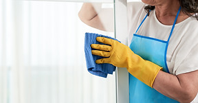 cropped-woman-cleaning-window-wearing-special-apron.jpg