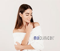 a lady with a long black hair smiling putting on white cloth 