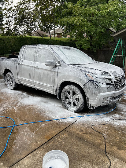 Truck covered in foam prior to rinse