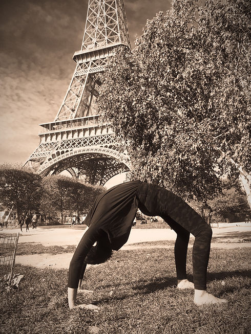 Tara Duffy in Urdhva Dhanurasana (Bridge Pose) in front of the Eiffel Tower, Paris (in sepia filter).).