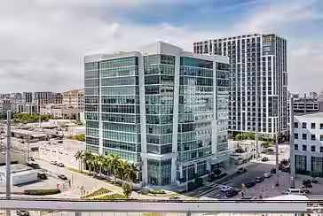 Glass office building in Miami’s Coral Gables business district near Coconut Grove, showcasing My Miami Office location with natural light and modern architecture.