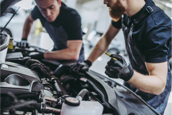 Men fixing a car under the hood at Family Auto Care.