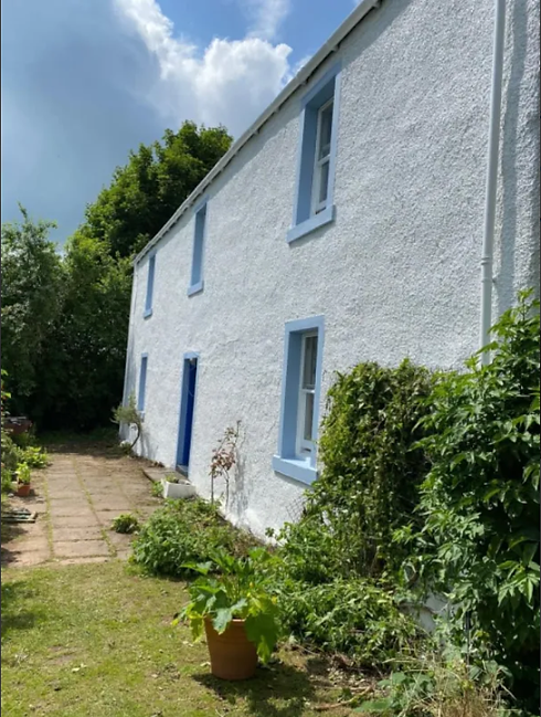 exterior of a property painted white with blue windowsills