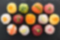 lots of colourful sushi on a slate plate