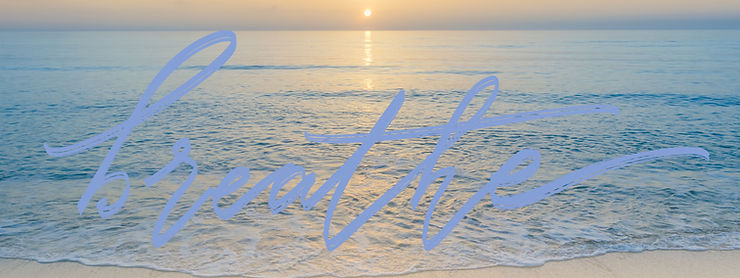 Tranquil sunrise over the ocean with the word "breathe" reminding us to find peace in nature's beauty.