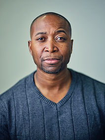 Headshot of male in grey sweater