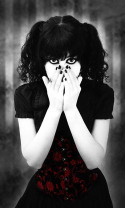 GothGirlHandsOverMouth.jpg