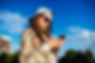 charming-young-woman-sunglasses-using-mobile-phone-SMALL.jpg