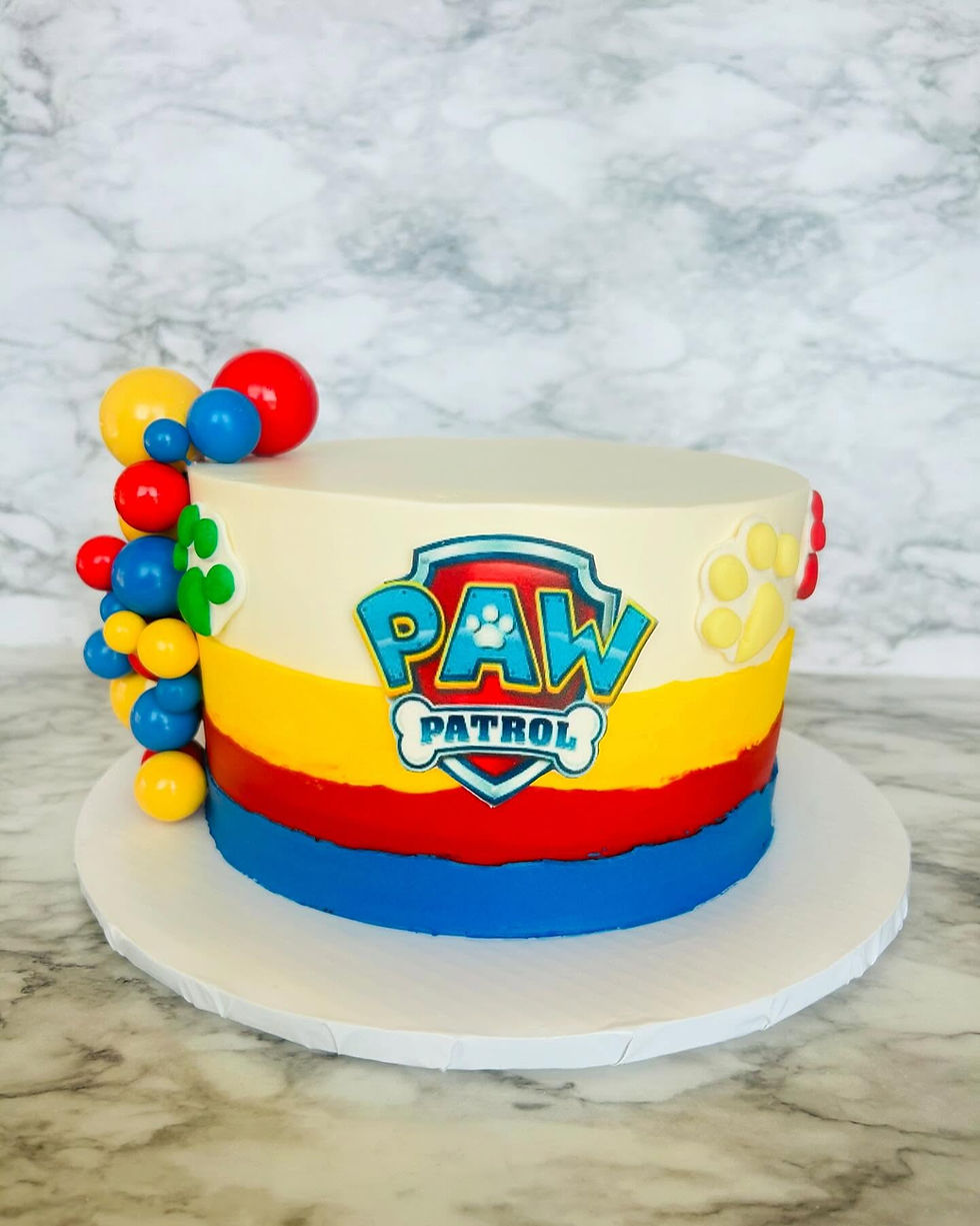 Paw Patrol themed birthday cake with bright colors and fondant toppers by AJ’s Sweet Creations Plano