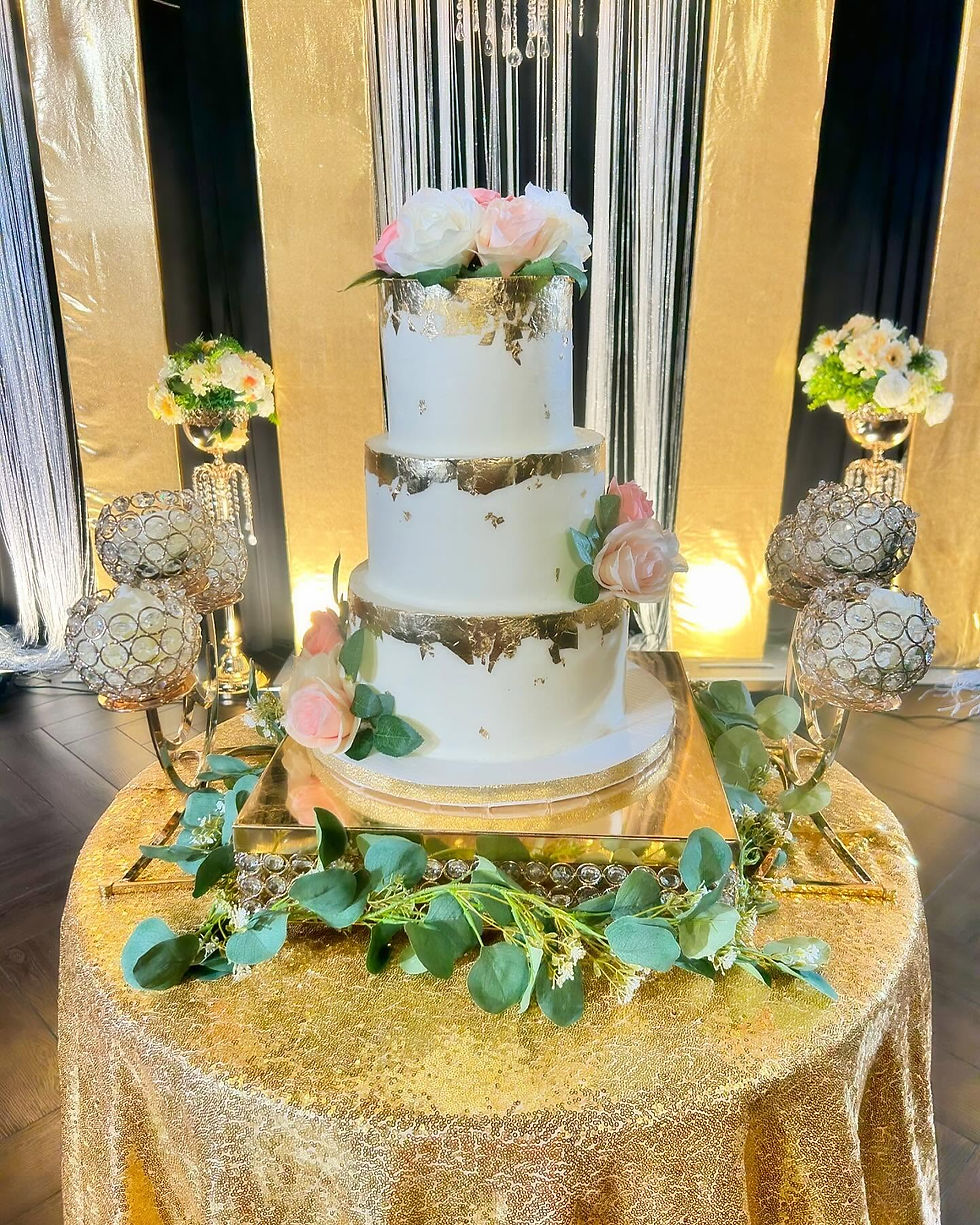 Tall white and gold wedding cake with cascading flowers by AJ’s Sweet Creations McKinney TX