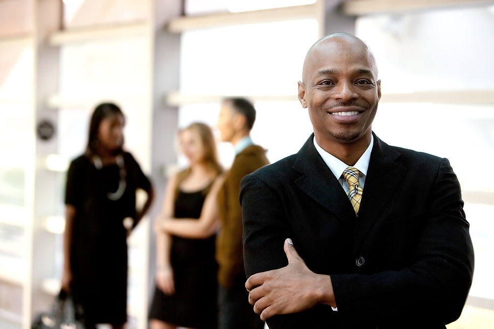 A happy black business man with people in the background_edited.jpg
