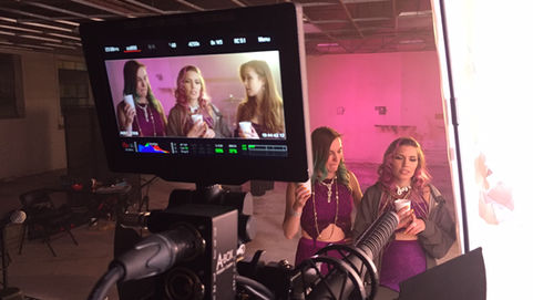RED camera framed up with women in the shot