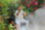 A Mayan shaman holding flowers and a ceremonial bowl as smoke rises during a spiritual blessing, sur