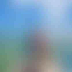 Two visitors standing on a wooden dock overlooking shallow turquoise waters in the Sian Ka’an Biosphere Reserve near Muyil.