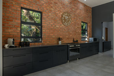 Grey quartz countertop with brick wall