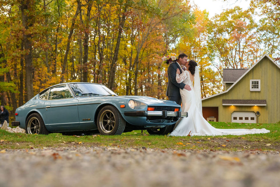 Woodland fairytale Michigan wedding on a crisp fall night with candlelit ceremony, lanterns, climbing florals, and custom signage