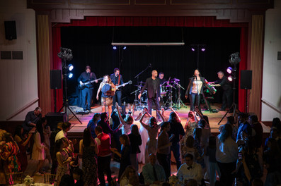 Intimate Michigan wedding with white floral ceremony, pops of red, personal table photos, and subtle Asian-inspired details