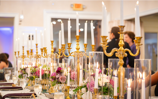 Elegant Michigan wedding with lush purple and rose gold florals, whiskey-inspired details, custom pup illustrations, and candlelight accents