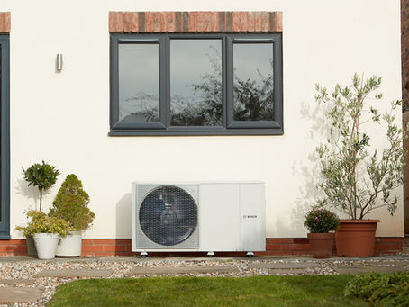 Air source heat pump on a detached property in rural Kent, running in cooling mode during summer