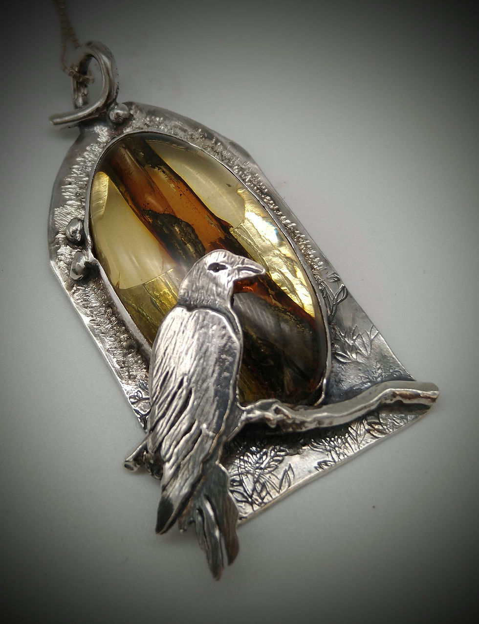 Thumbnail: Sterling Silver Raven Pendant with Natural Amber