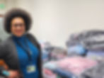 An African American Woman in a blue shirt with an afro