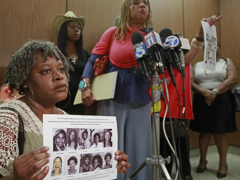 Black Women at a press conference for missing Black girls holding a picture with 10 victims o