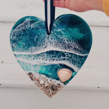 A video of a beautiful blue ocean resin heart