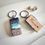 Thumbnail: A rectangle wooden keychain with a ocean resin design and cremation ashes beach.