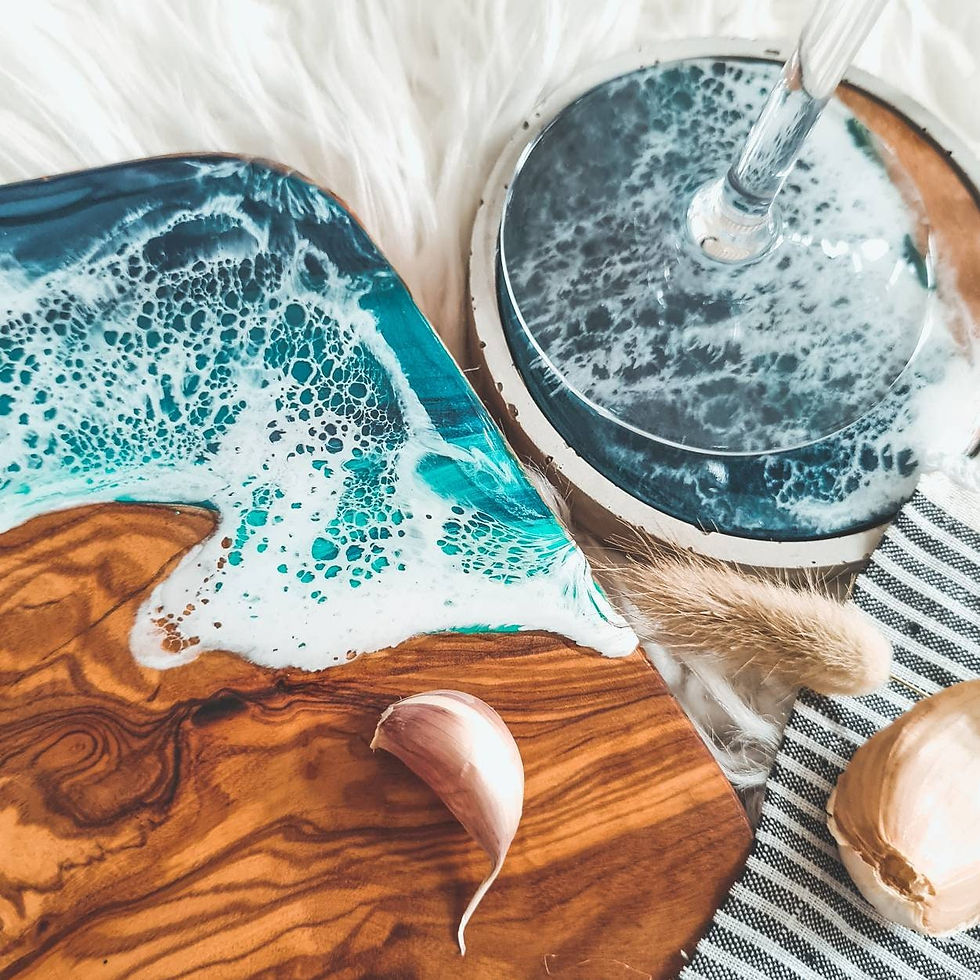 Thumbnail: An olive wood ocean resin board next to a ocean resin concrete coaster. The board displays the intricate details of the ocean like it's colours and the waves.
