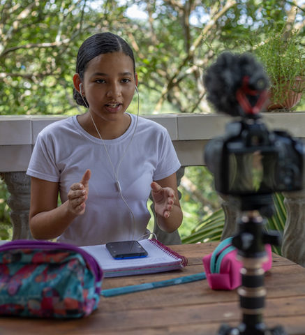 Young woman recording a video for Youtube