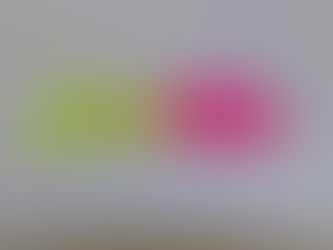 A shad tube with a pink body and chartreuse skirt
