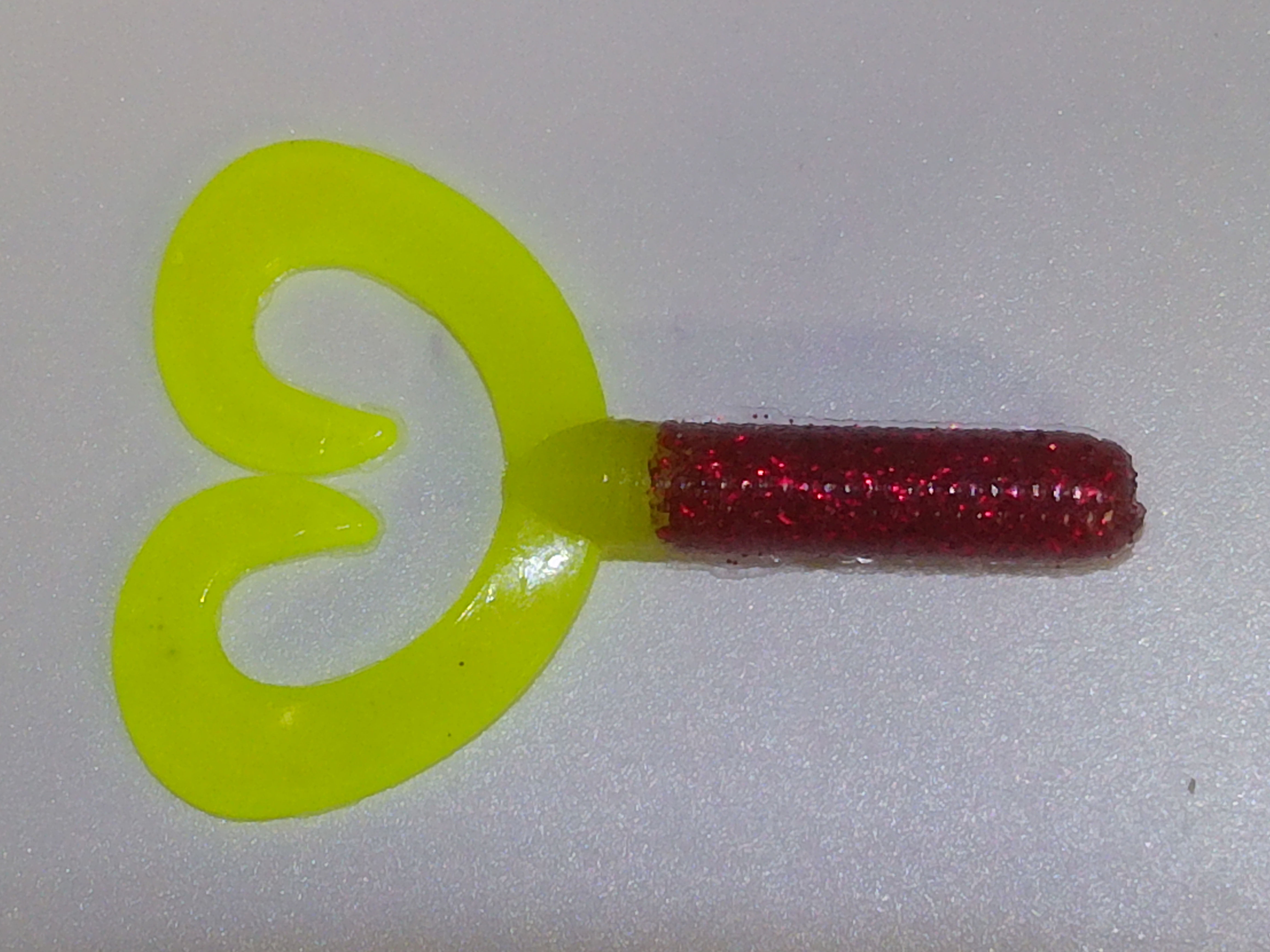 chartreuse lure tail connected to a red body