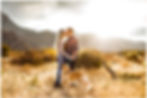 Couple kissing with dog in field | Jennifer Bowen Photography