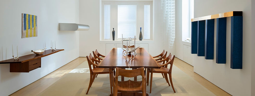 George Nakashima dining table and Sam Maloof chairs in the middle of works by Richard Tuttle, Donald Judd and Sol LeWitt.