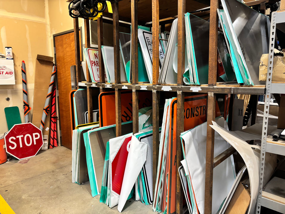 Traffic signs stored on shelves, stop sign on left