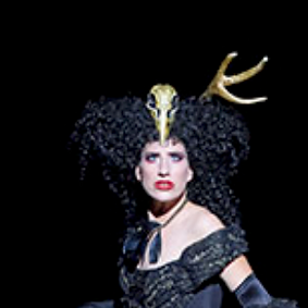 coloratura soparno MORGANE HEYSE as Queen of the Night in Mozart's The Magic flute in balck costume with gold at opera Linz, austria